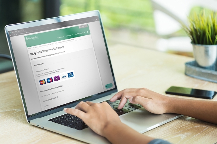 An image of a laptop showing West Berkshire Council's online form to apply for a street works licence