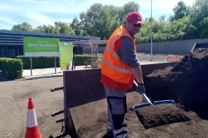 Man shovelling soil conditioner