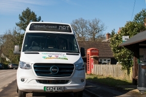 A picture of the Community Connect Thatcham Connect bus by a bus stop at Chapel Row. 