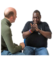 A person sitting and talking to another person.