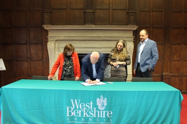 Councillor Jeff Brooks signing the Memorandum of Understanding.